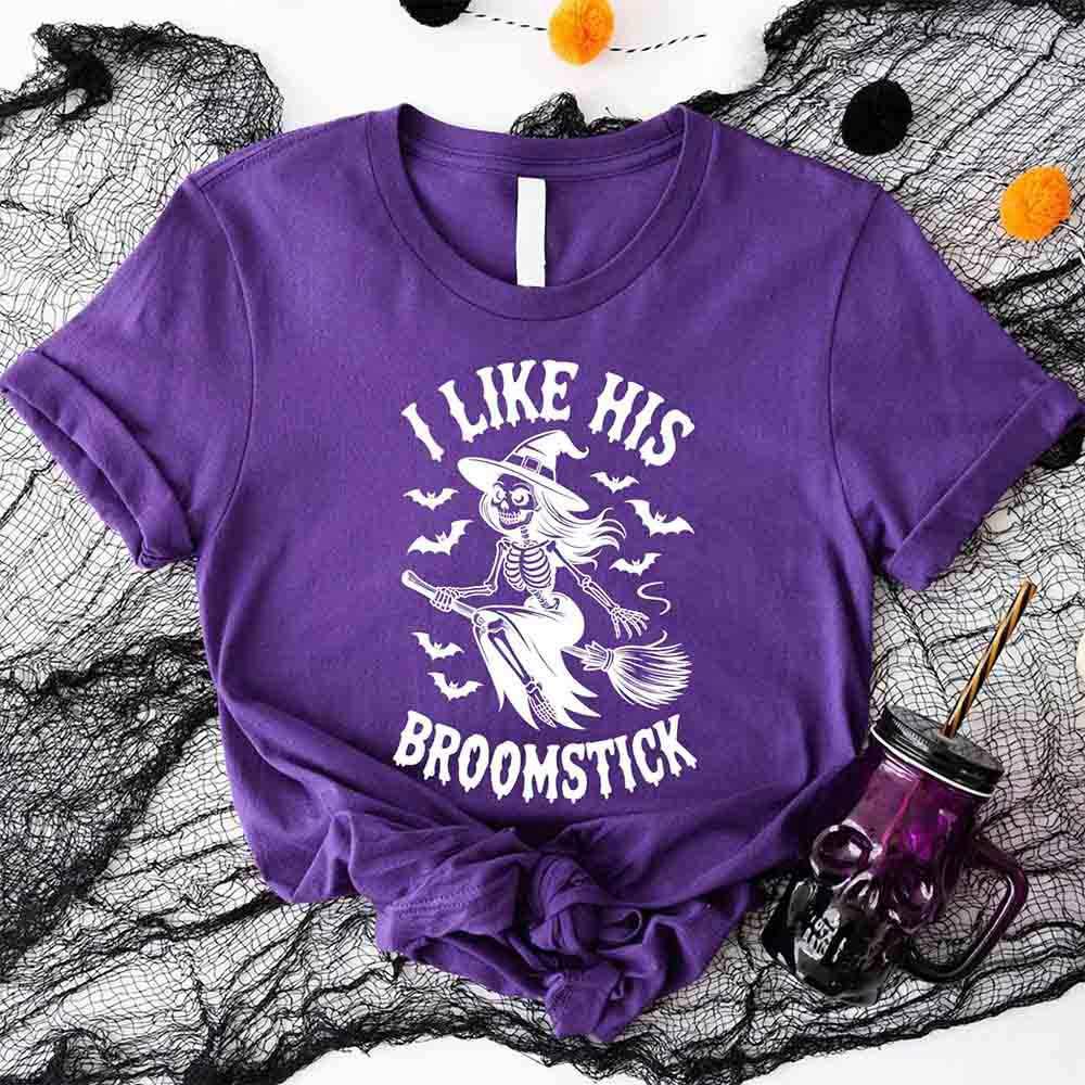 Purple Halloween T-shirt with witch skeleton graphic and “I Like His Broomstick” text