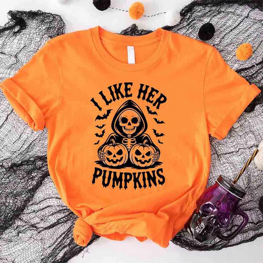 Orange Halloween T-shirt with black skull and pumpkins graphic and “I Like Her Pumpkins” text