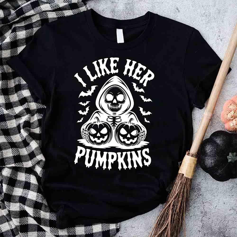Black unisex T-shirt with “I LIKE HER PUMPKINS” skull and jack-o’-lantern graphic