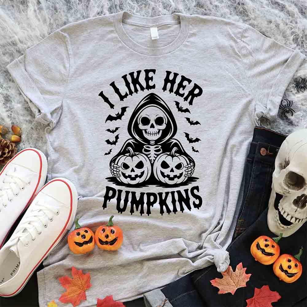 Light gray Halloween T-shirt with skull and pumpkins graphic and “I Like Her Pumpkins” text