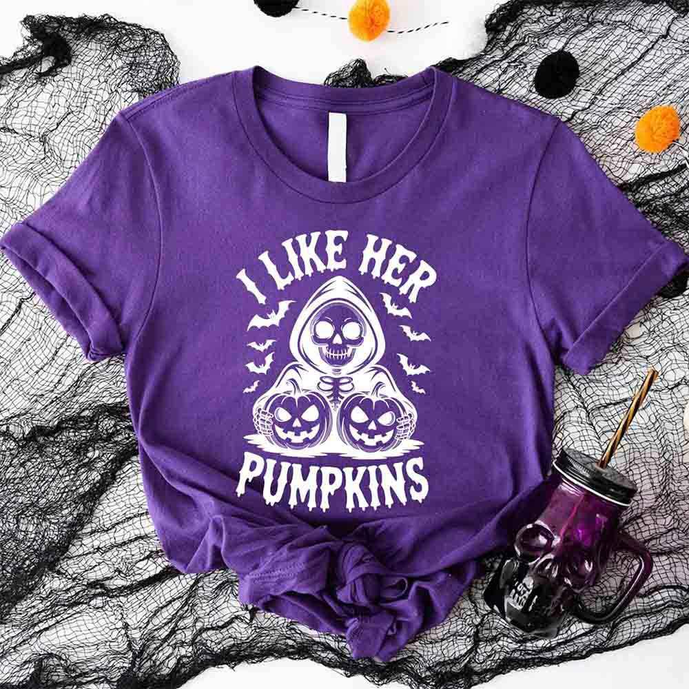 Purple Halloween T-shirt with skull and pumpkins graphic and “I Like Her Pumpkins” text