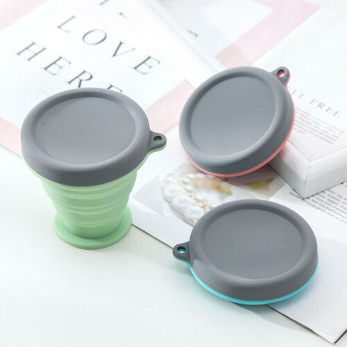 Collapsible silicone travel coffee cups in mint, pink, and teal with gray lids and loops