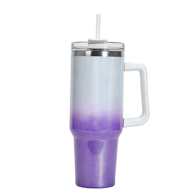 Insulated stainless steel tumbler with silver-to-purple gradient finish, handle, and clear lid