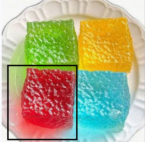 Red translucent squishy cube highlighted; green, yellow, and blue cubes included.