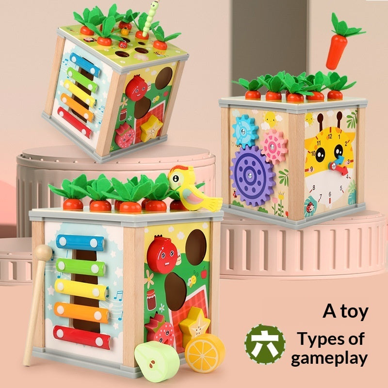 Stacked wooden activity toy cubes with colorful gears, xylophone bars, and bead elements