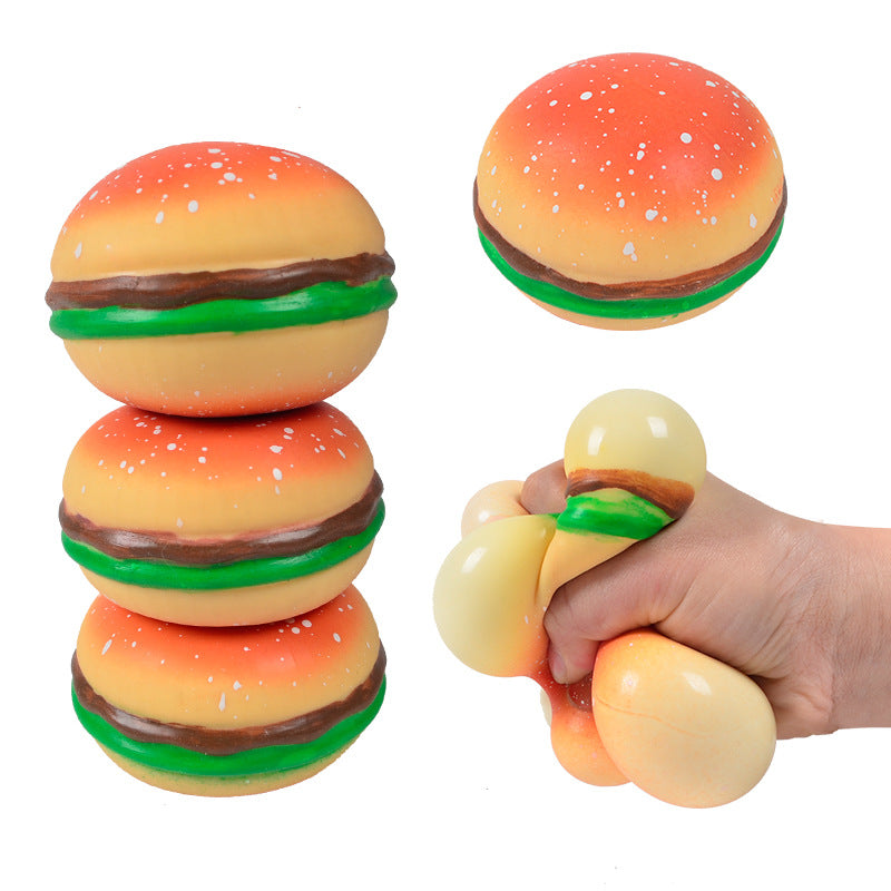 Burger squishy stress relief balls beside ice cream cone squishy in hand