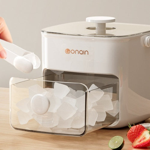 Milky white ice cube maker with clear window, open lid, and ice cubes in the tray