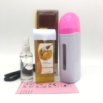 Portable wax machine in pink and white with warming chamber and spatula
