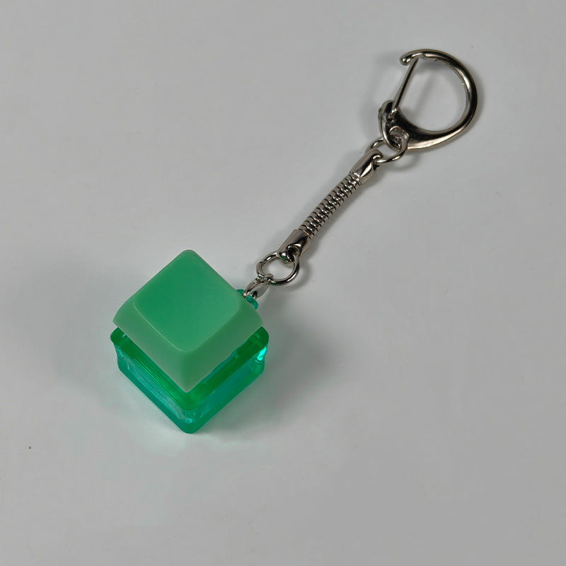 Green square finger-popping stress-relief keychain toy with metal chain and rings