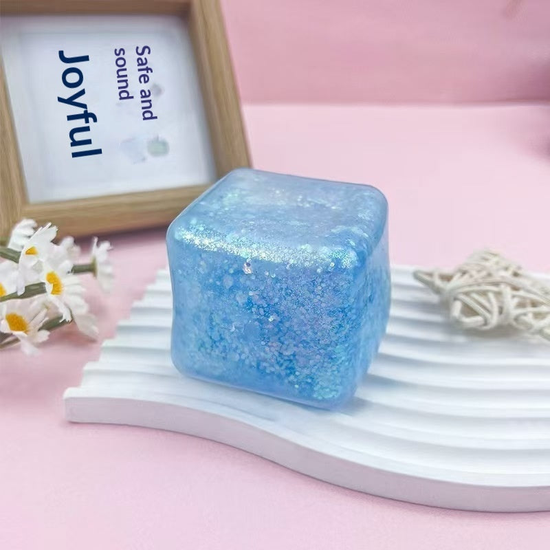 Light blue water-cube stress-relief squishy toy with glitter speckles, translucent