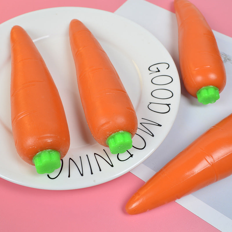 Orange carrot-shaped stress relief toys on a white plate with green caps