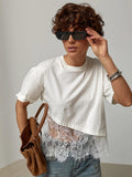 White short-sleeve crewneck blouse with lace patchwork hem and mesh overlay