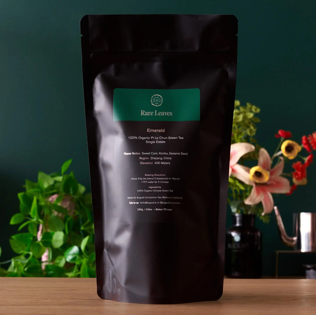 Emerald green tea pouch with Rare Leaves label on dark bag