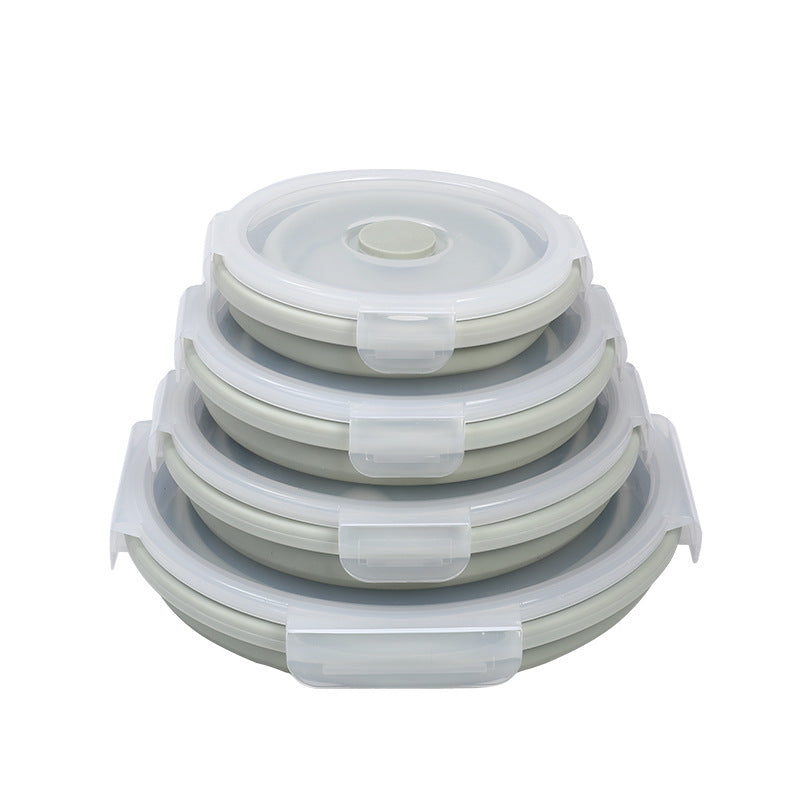 Stack of pale green silicone lunch containers with clear snap lids