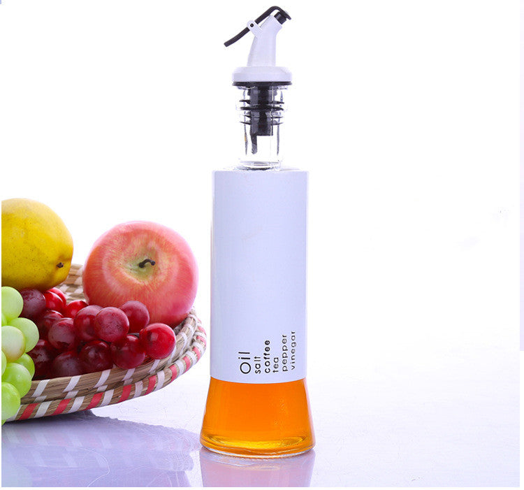 Glass oil dispenser bottle with white pump top, white body and amber liquid base
