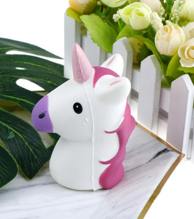 Slow-rising squishy toy white unicorn with pink ears and purple mane detail