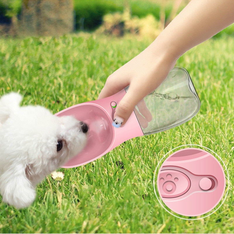 Portable pet water bottle with filter, pink bottle pouring water for a small dog