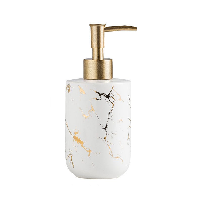 Marble-pattern dispenser bottle with gold pump; white bottle with golden marble veining