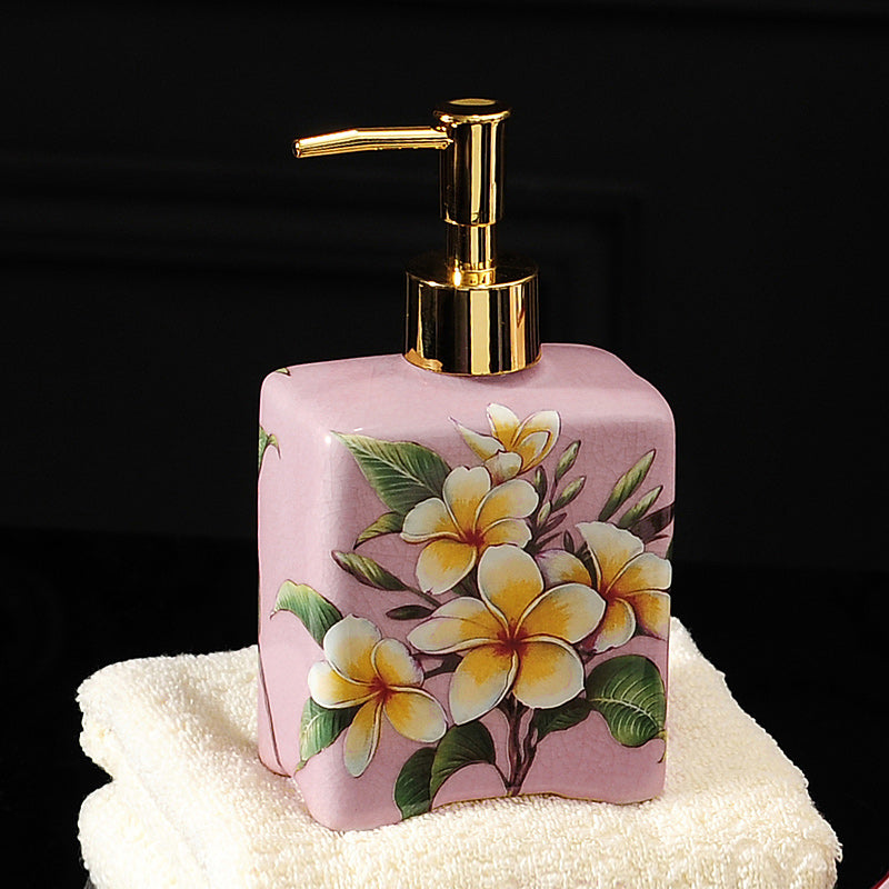 Hand-painted ceramic dispenser bottle, light pink with yellow flowers, gold pump, square shape