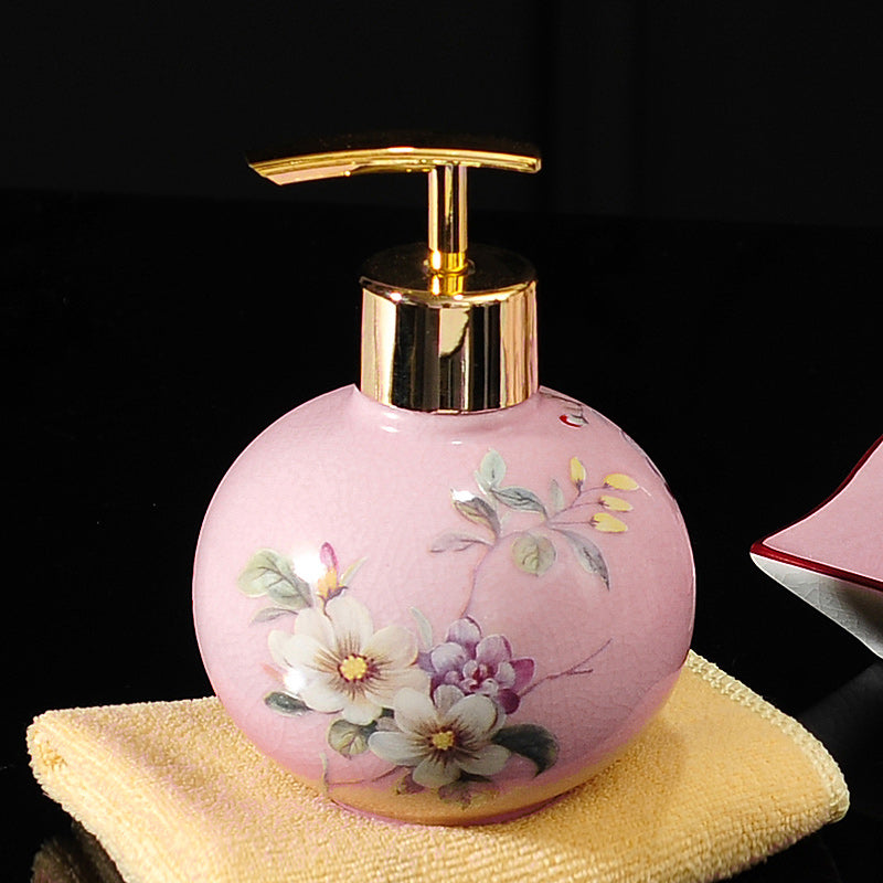 Hand-painted ceramic dispenser bottle, pink round with multicolor flowers, gold pump