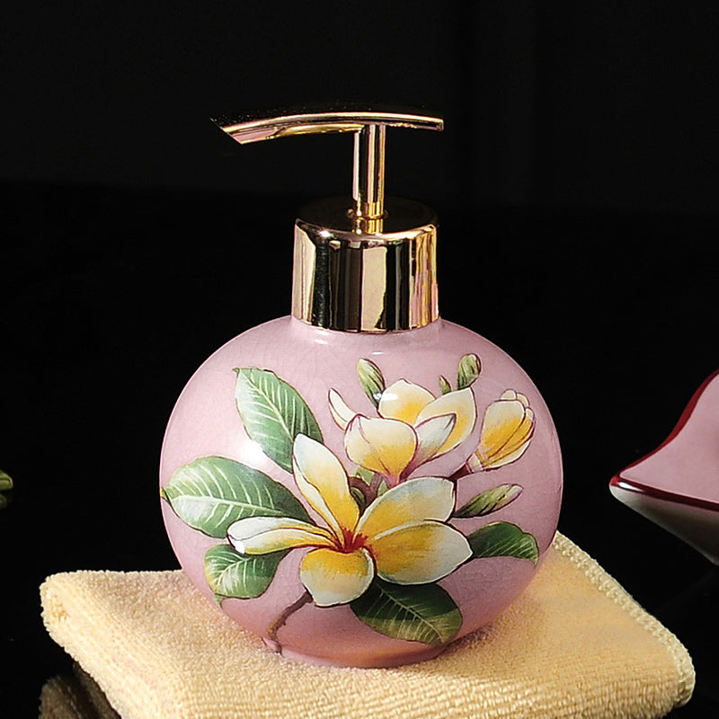 Hand-painted ceramic dispenser bottle, pink round with white-yellow blossoms, gold pump