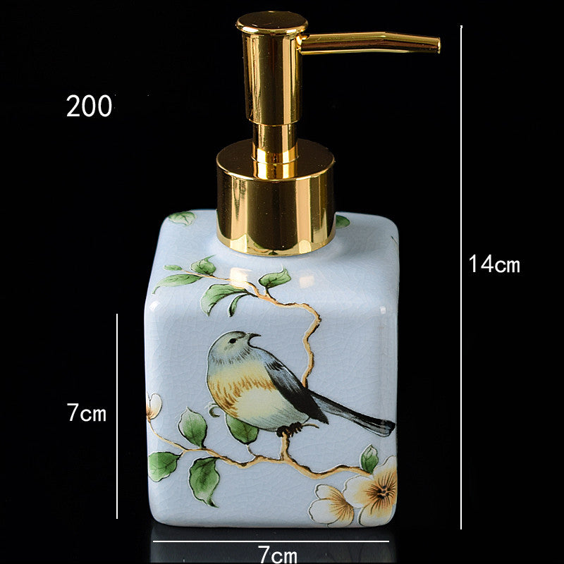 Hand-painted ceramic dispenser bottle, light blue with bird-and-flowers scene, gold pump, square