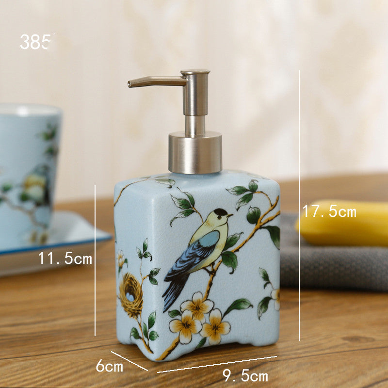 Hand-painted ceramic dispenser bottle, light blue with bird and blossoms, gold pump, square