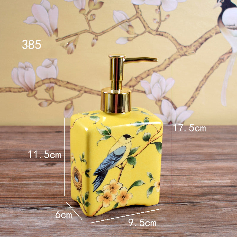 Hand-painted ceramic dispenser bottle, yellow with bird and flowers, gold pump, square shape