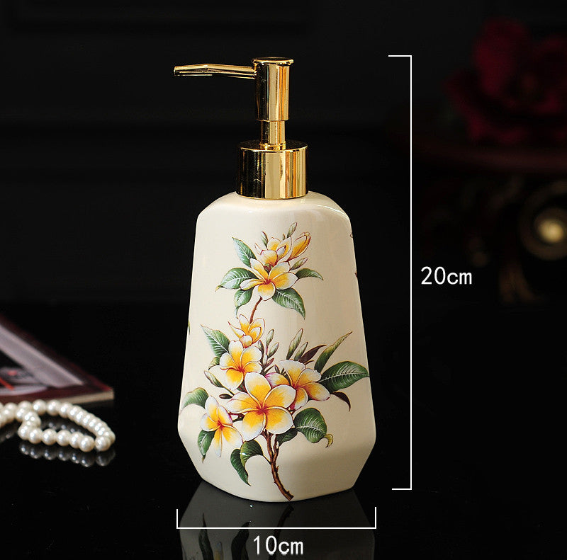 Hand-painted ceramic dispenser bottle, white with orange floral cluster, gold pump, rectangular shape
