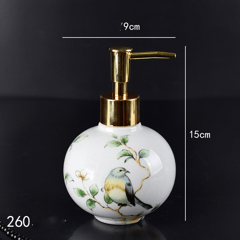 Hand-painted ceramic lotion/soap dispenser bottle, round white with bird and gold pump