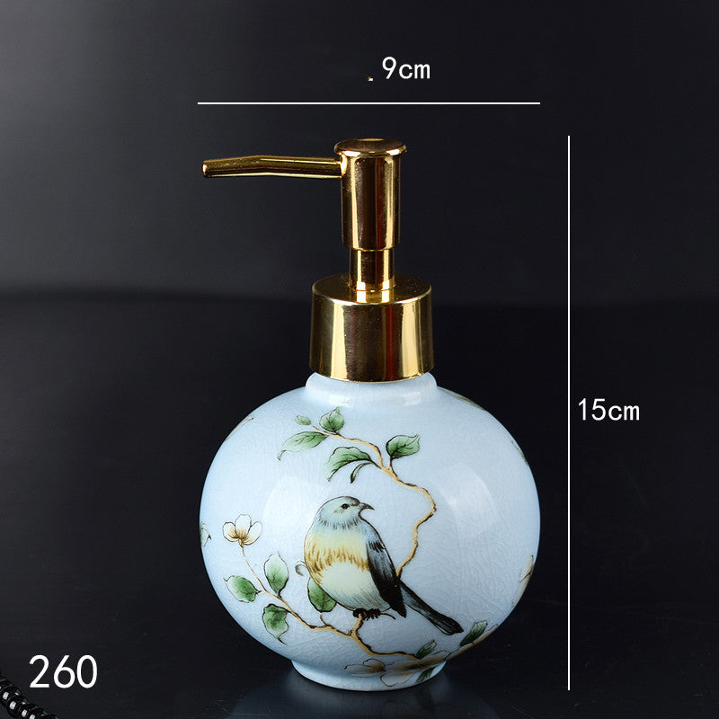 Hand-painted ceramic lotion/soap dispenser bottle, light blue round with bird and gold pump