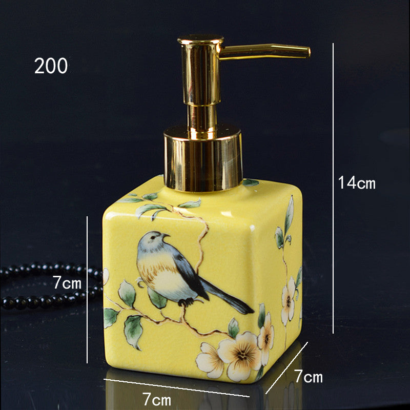 Hand-painted ceramic lotion/soap dispenser bottle, yellow square with bird and gold pump