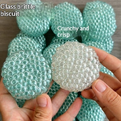 Mint-green textured stress-relief ball with bubbled pattern, held in hands