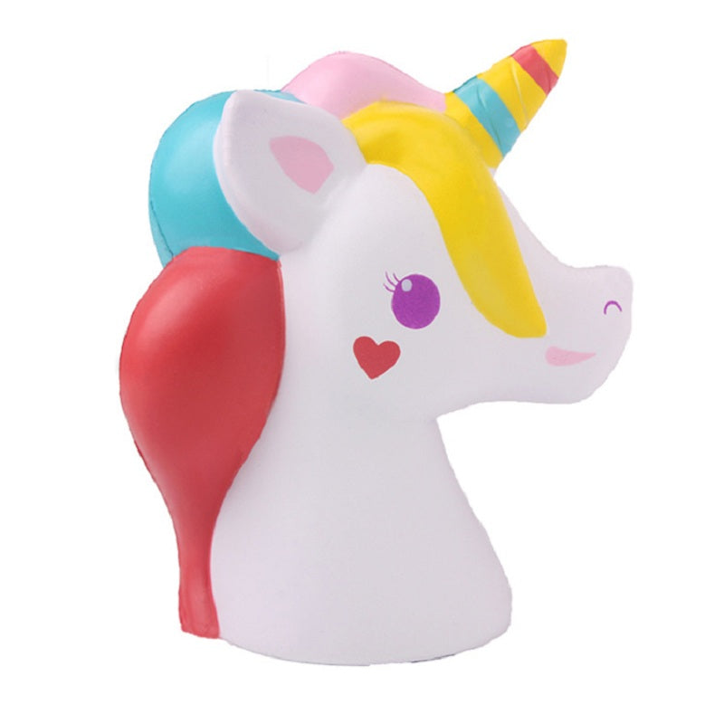 Unicorn plush toy with white body, rainbow horn and mane, smiling heart cheek marks.