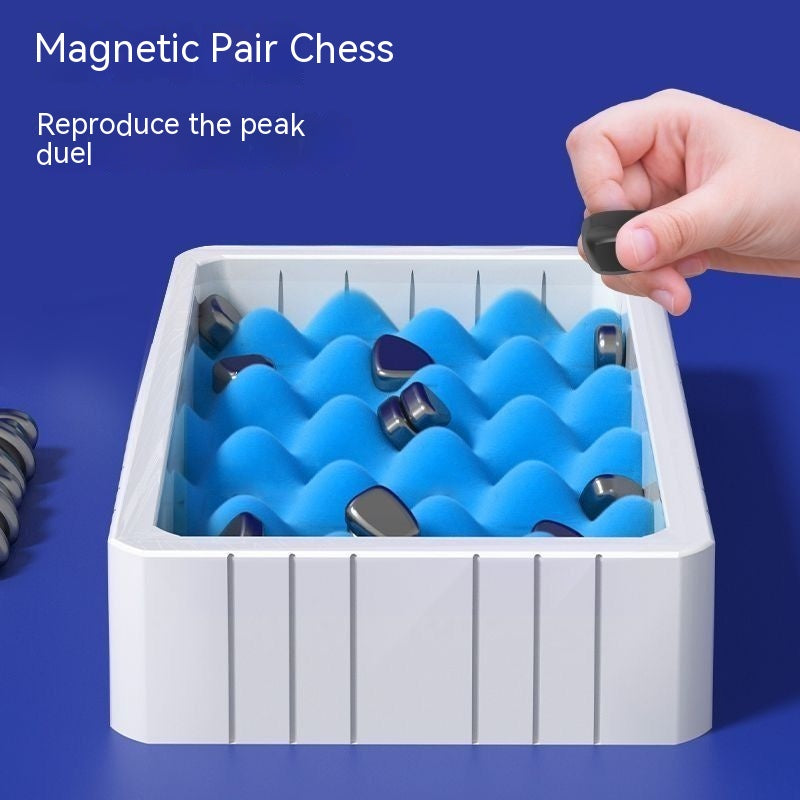 Magnetic pair chess tray with blue magnets and a hand holding a piece