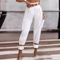 White wide-leg cargo trousers with brown contrast belt and multiple side pockets