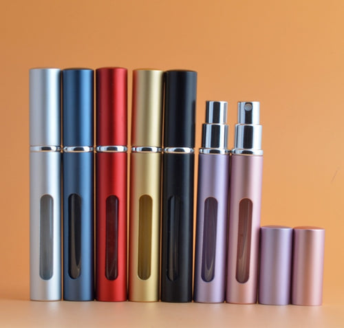 Set of aluminum perfume spray bottles with mirrored caps and oval dispense windows