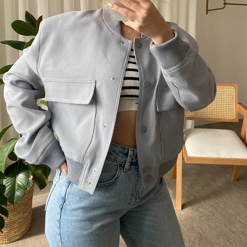 Light gray button-up stand-collar jacket with chest pockets and ribbed cuffs