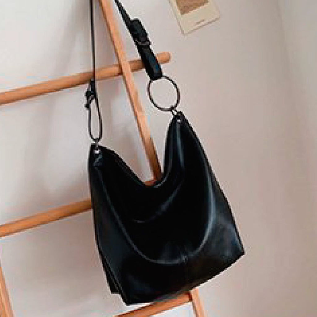 Black slouch shoulder bag with ring strap and top zipper closure