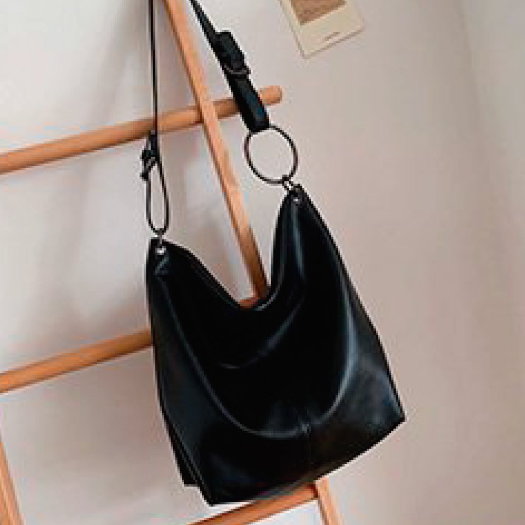Black slouch shoulder bag with ring strap and top zipper closure