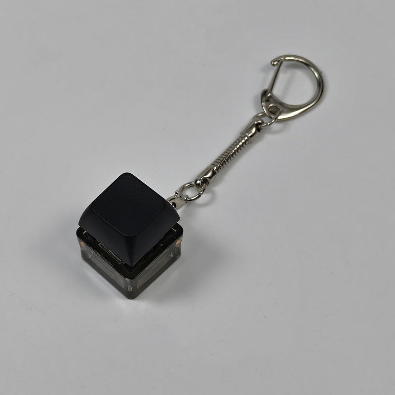 Black square finger-popping keychain toy with spring chain and snap buttons