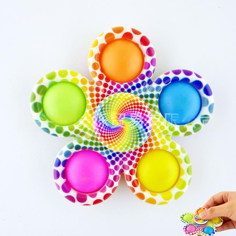 Polka-dot fidget spinner with six bright button tips and rainbow swirl center disc.