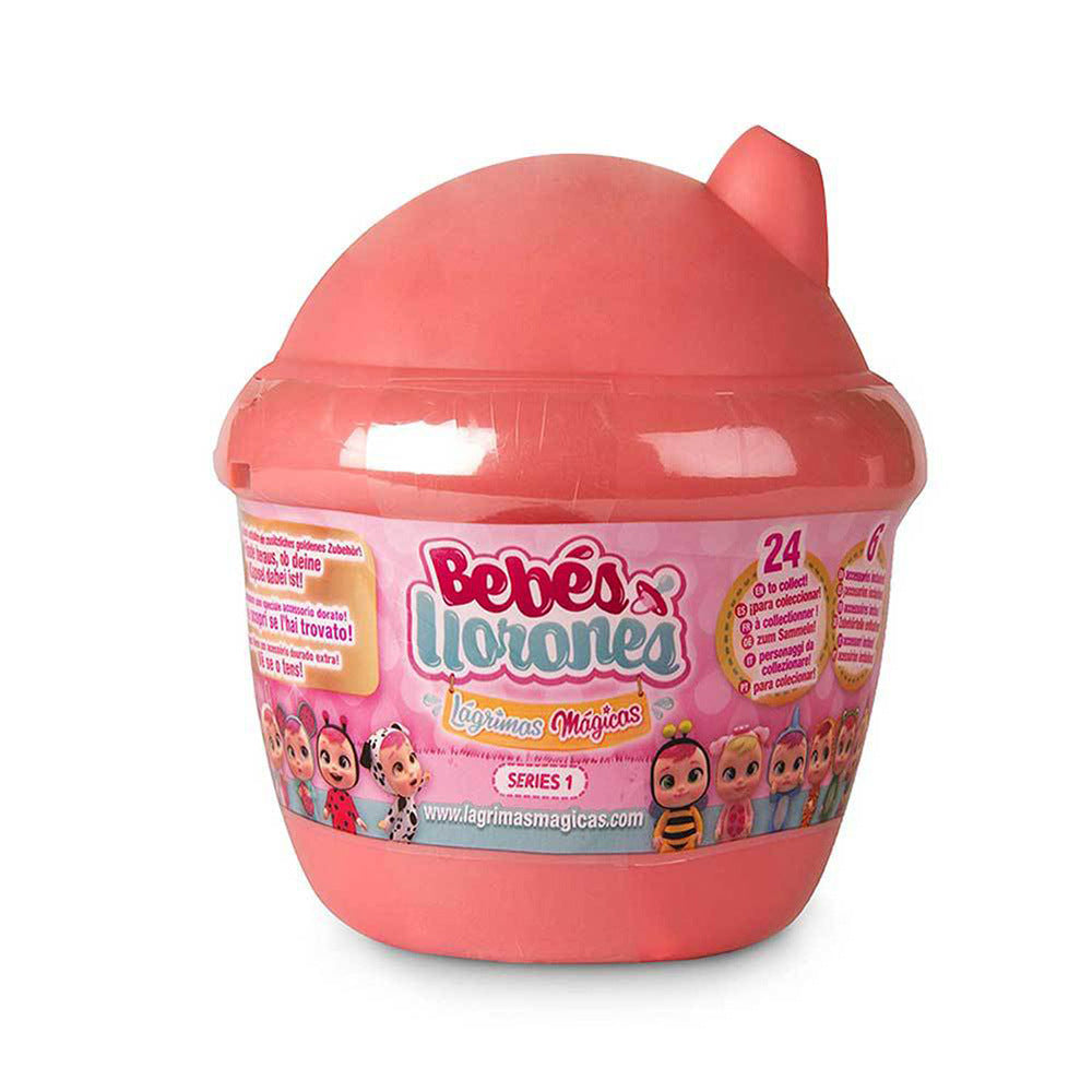 Blind box baby doll toy in pink cup-shaped container with Bebés Llorones logo