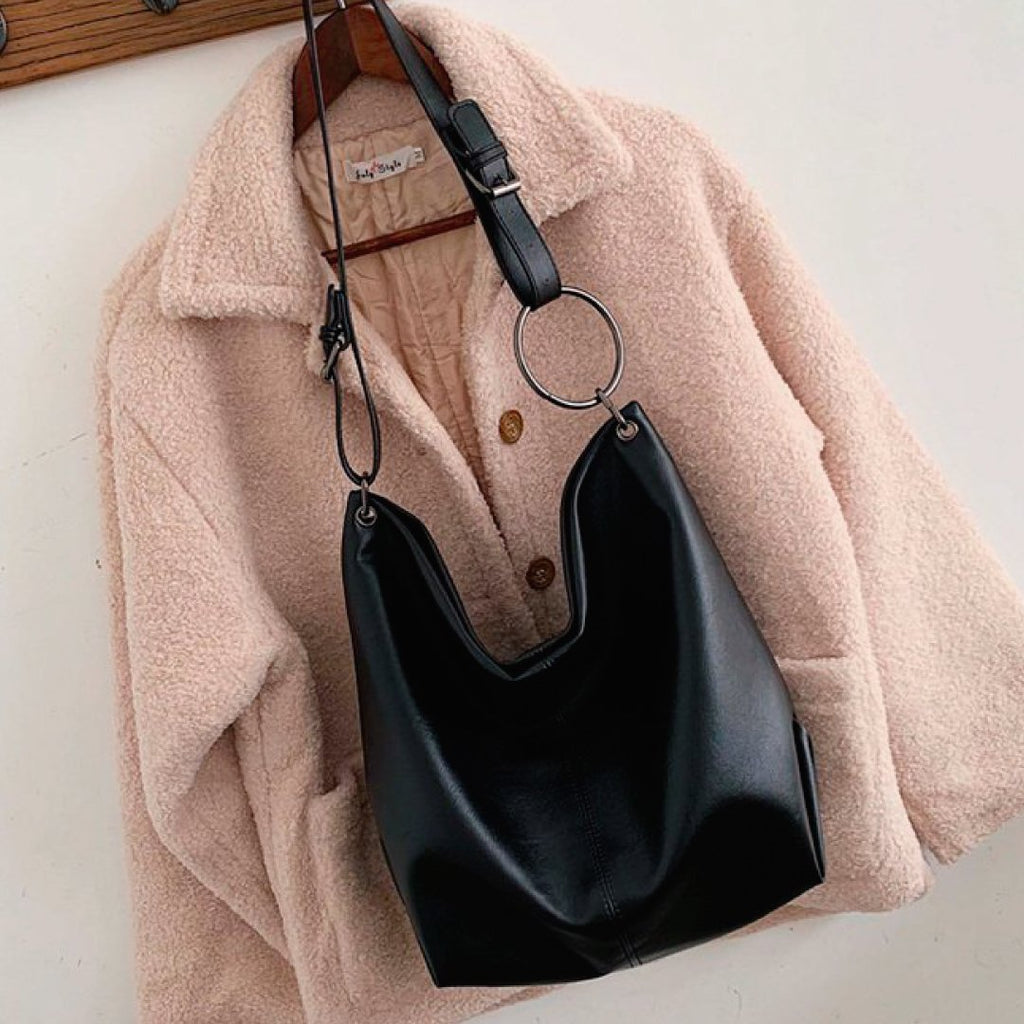 Black shoulder bag with O-ring strap and slouchy hobo shape