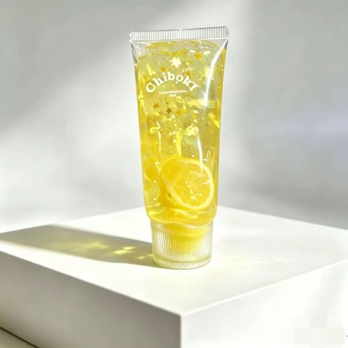 Yellow squishy toothpaste squeeze toy tube with lemon slice and star glitter