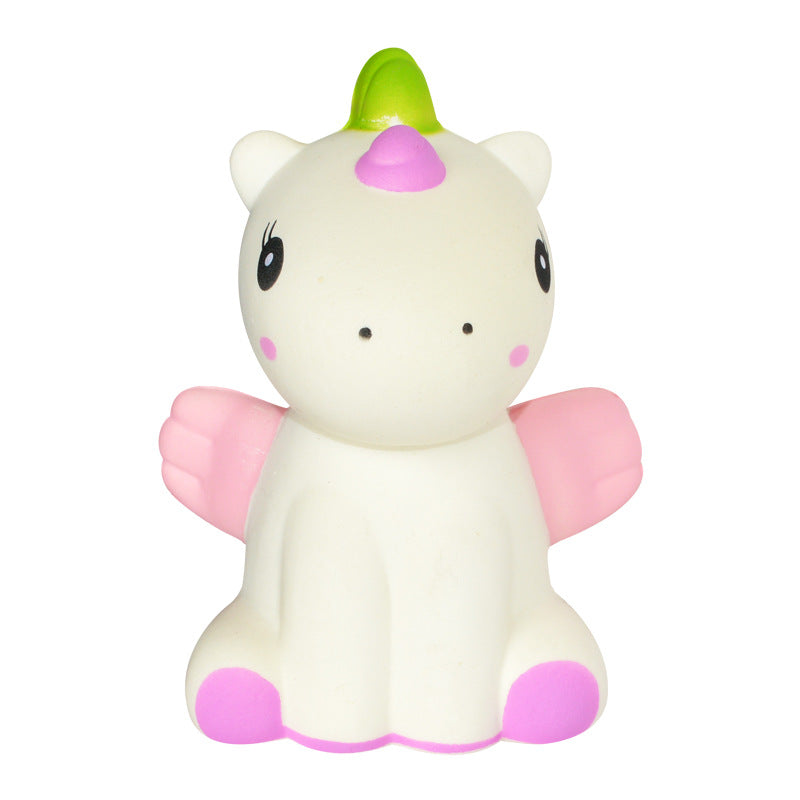 White unicorn squishy toy with green horn, purple nose, and pink winged arms