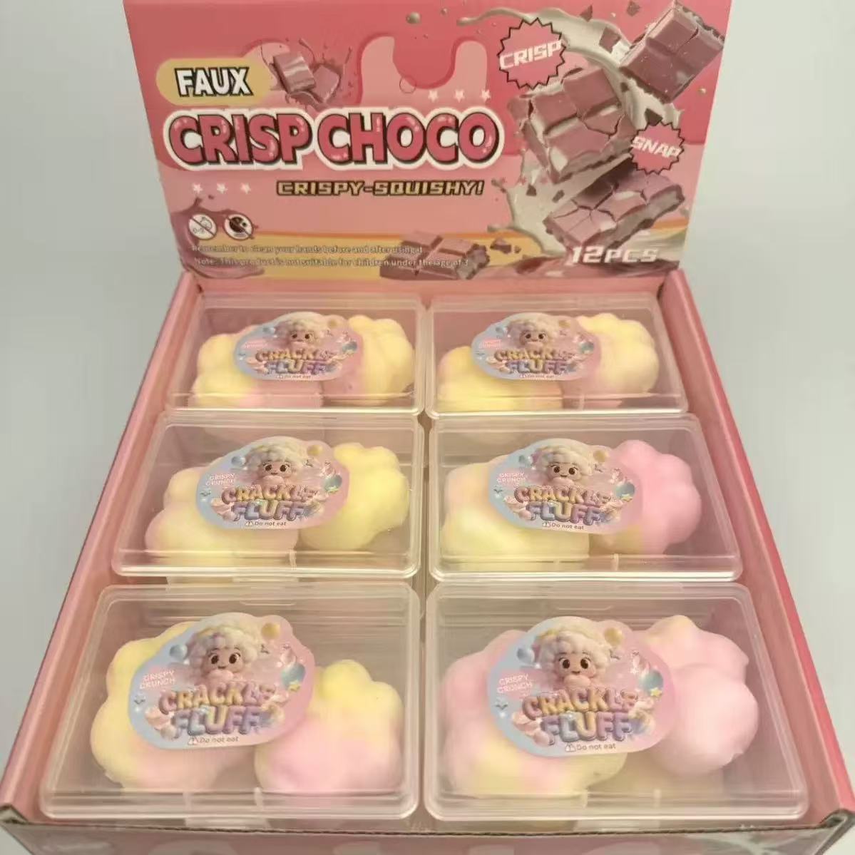 Pink CRISPCHOCO squeeze toy set in open box with clear compartments and pastel bars