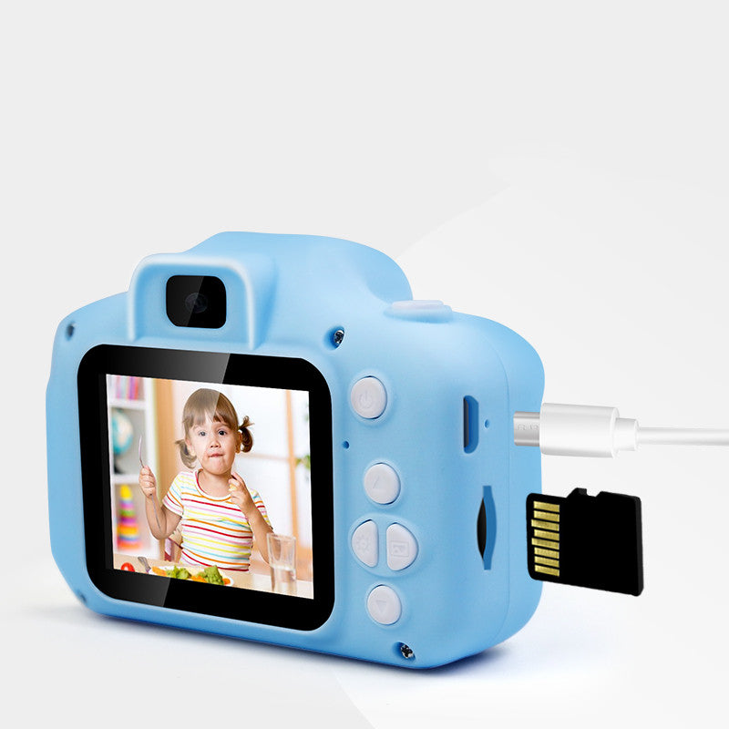 Kids' digital camera toy in light blue, color screen with photo, and card slot shown on side