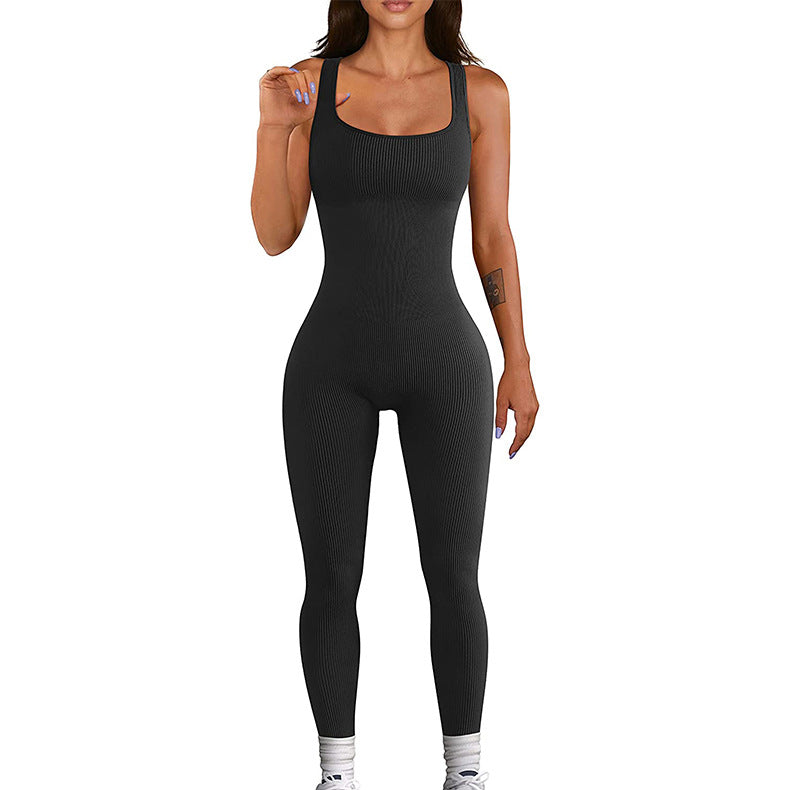 Black fitted one-piece workout bodysuit with scoop neck and long leggings legs.