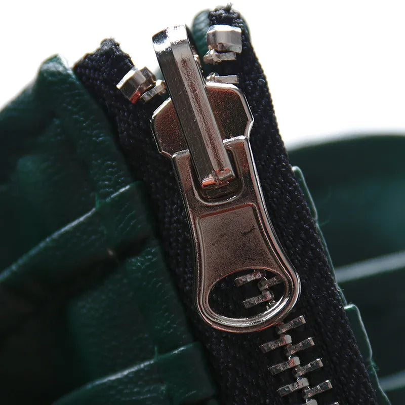 High-waist leather skirt zipper detail, dark green/black with metal pull
